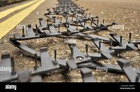 general-view-police-stinger-spike-strip-deployed-road-next-g6gk77-jpg