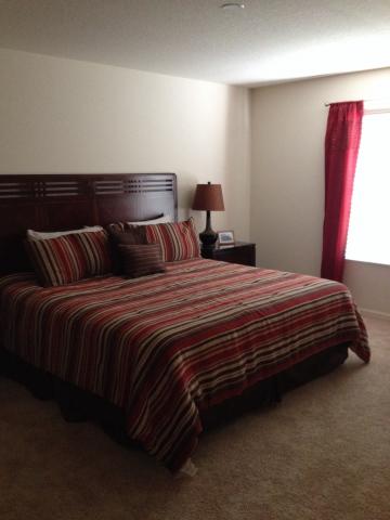 King bed in master bedroom with 32" HD television.