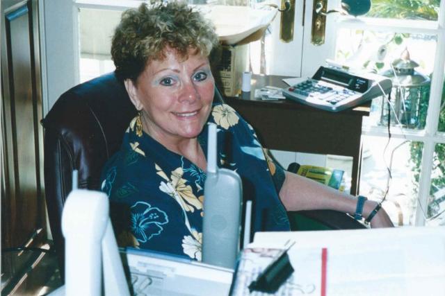 Susan in her home office overlooking the ocean