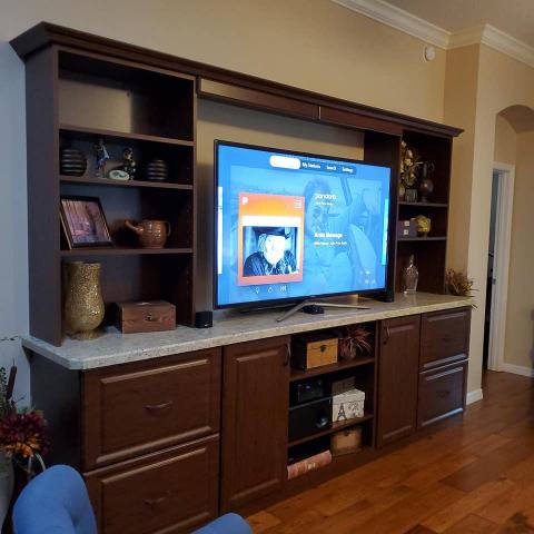 Custom Entertainment TV unit with drawers for storage with laminate countertop open shelving in color chocolate apple.