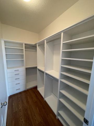 Closet Small White Walk IN corner double hang and shelving units with drawers and shelving.