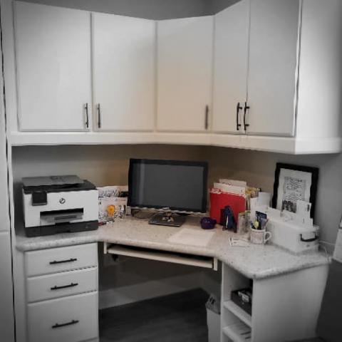 Corner Office with knee space and upper and lower storage and keyboard tray.