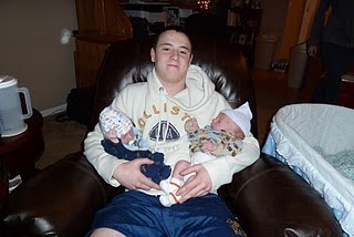 Holding his twin cousins