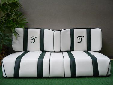 White short wingback with 2" green and green trim and "T" in script font embroidery.