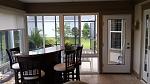 Picture windows with horizontal sliders above and a new fiberglass door with full lite.